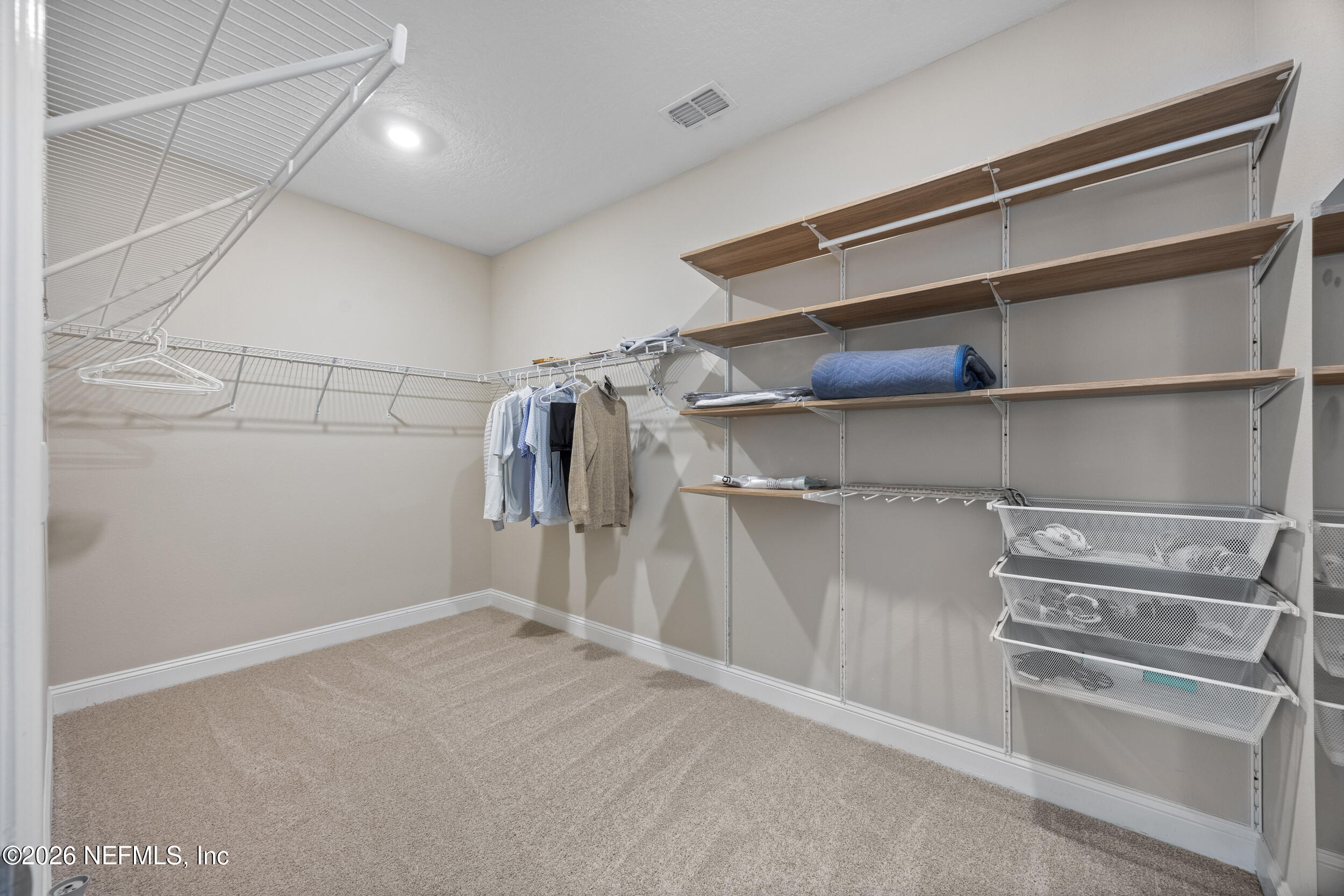 196 Silver Reef Lane St. Augustine, FL 32095 - Photo 28 of 62 a view of walk in closet with empty racks