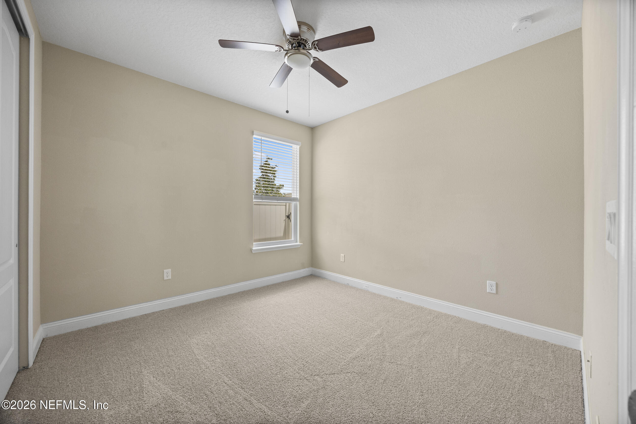196 Silver Reef Lane St. Augustine, FL 32095 - Photo 31 of 62 an empty room with a chandelier fan and windows