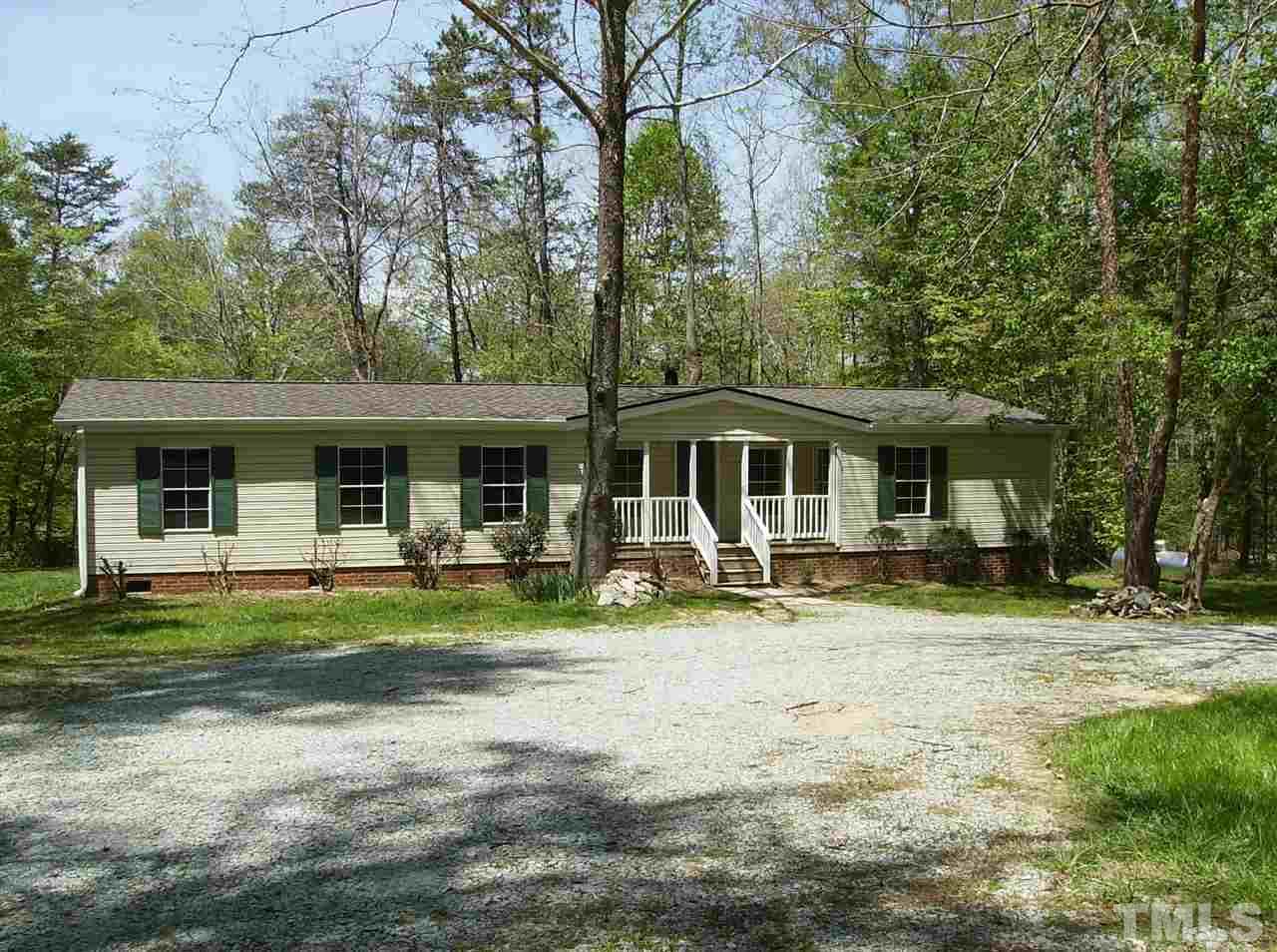 1077 Harris Mill Road Rougemont, NC 27572 - Photo 3 of 9 a front view of a house with swimming garden and porch
