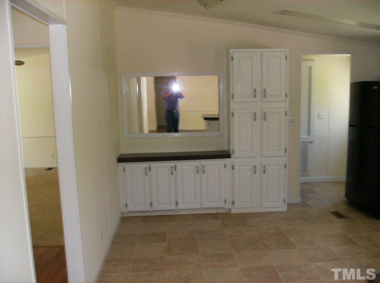 1077 Harris Mill Road Rougemont, NC 27572 - Photo 5 of 9 an empty room with mirror