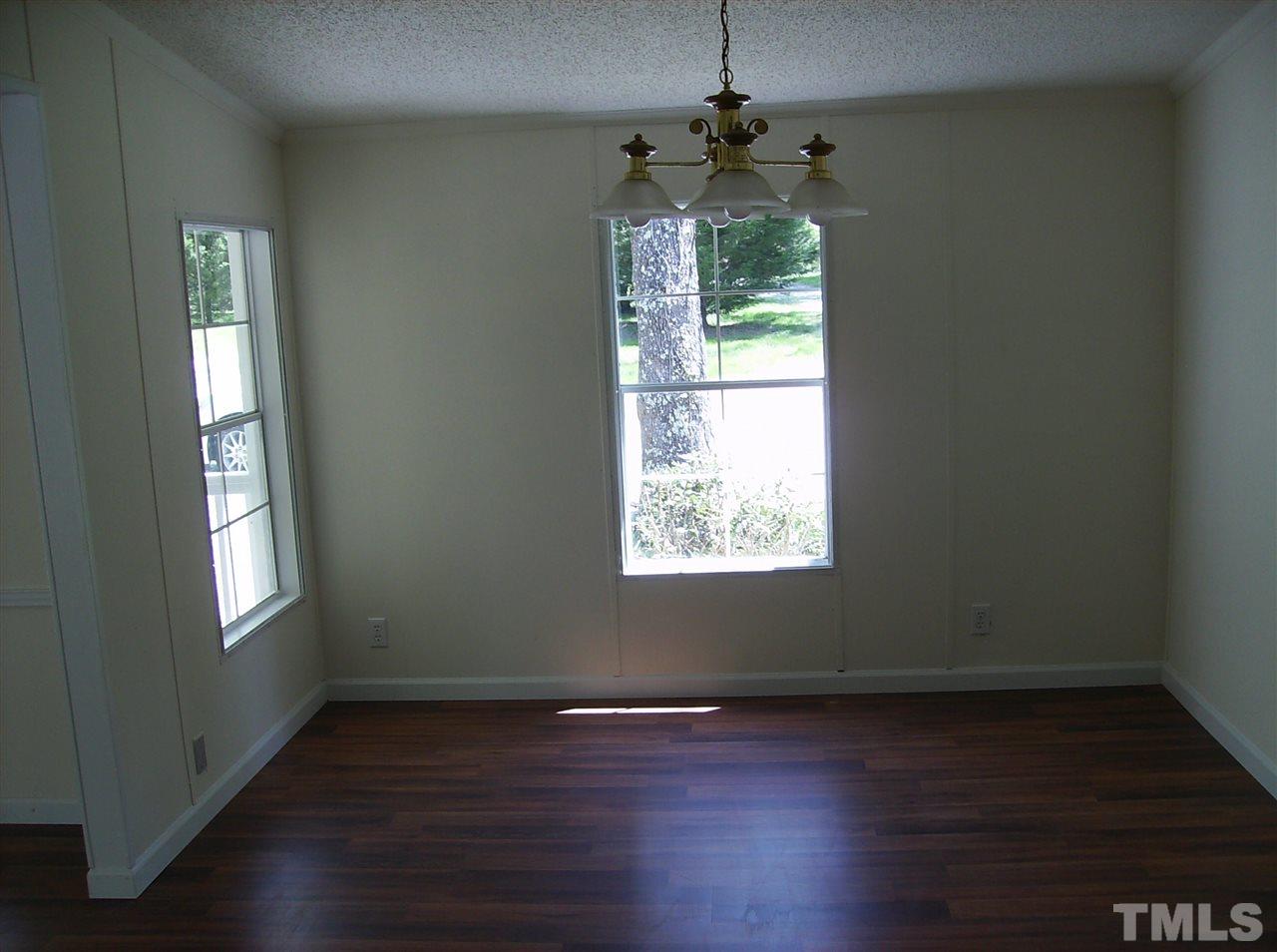 1077 Harris Mill Road Rougemont, NC 27572 - Photo 6 of 9 a view of an empty room with wooden floor and a window