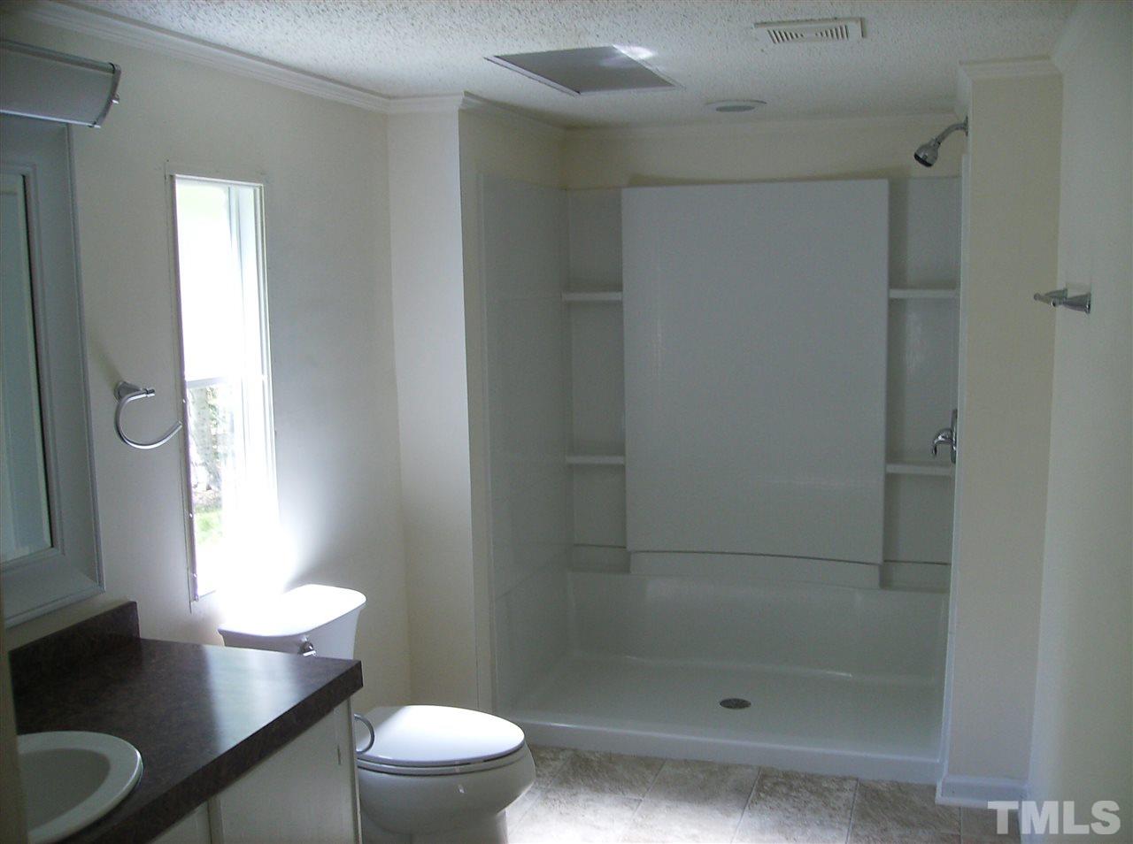 1077 Harris Mill Road Rougemont, NC 27572 - Photo 7 of 9 a bathroom with a bathtub and a toilet
