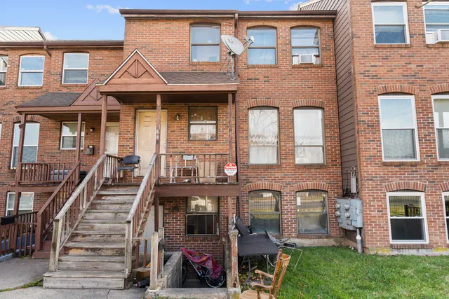 front view of a brick house with a small yard