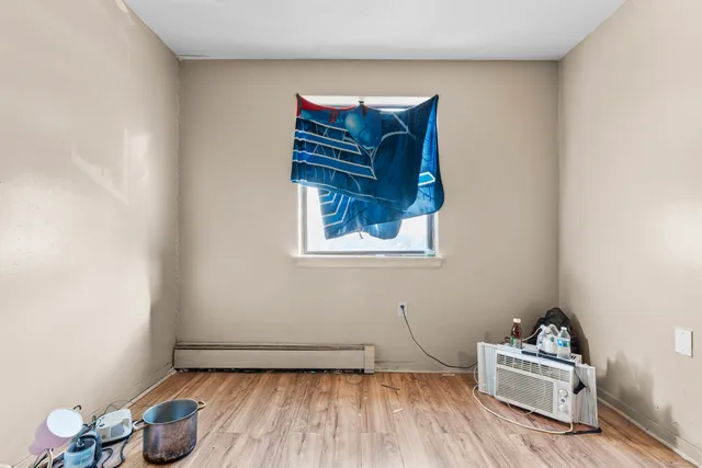 a room with a wooden floor and a window