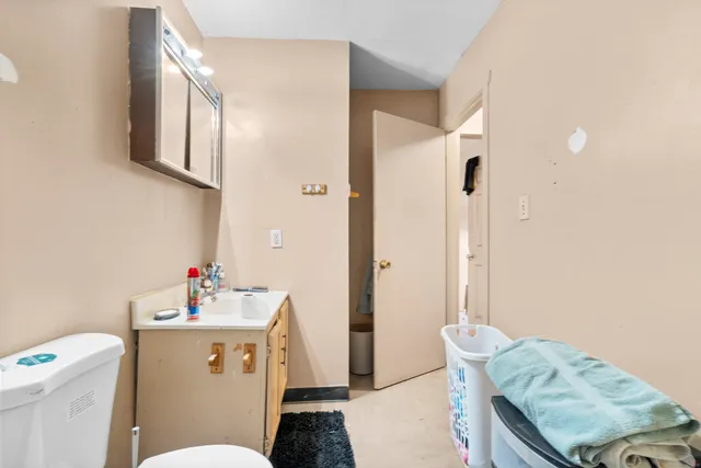 a bathroom with a sink toilet vanity and tub