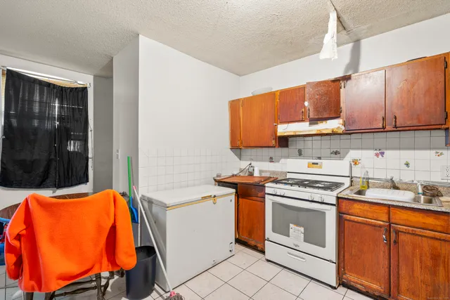 a kitchen with stainless steel appliances a stove a sink and a refrigerator