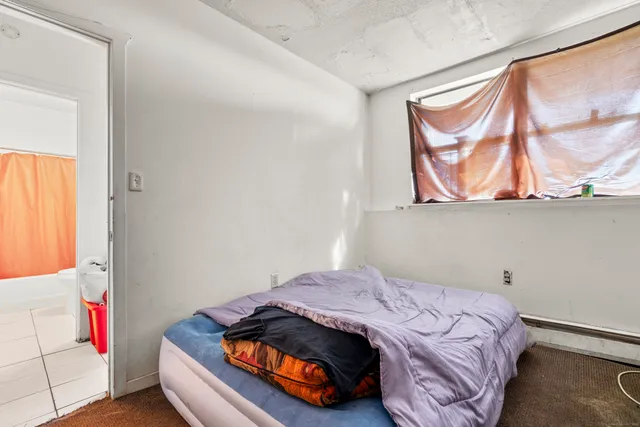 a bedroom with a bed and window
