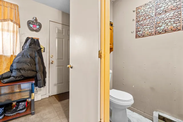 a bathroom with a toilet and a shower curtain