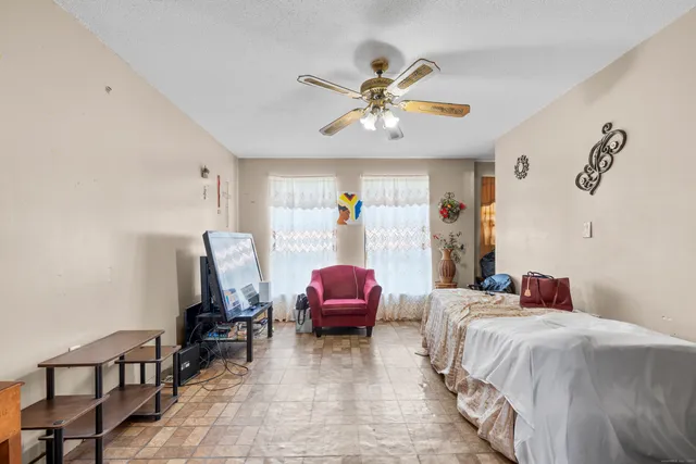 a bedroom with a bed and a chandelier
