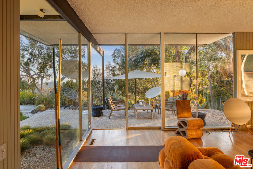 1531 North Tigertail Road Los Angeles, CA 90049 - Photo 3 of 24 a living room with furniture and a glass door