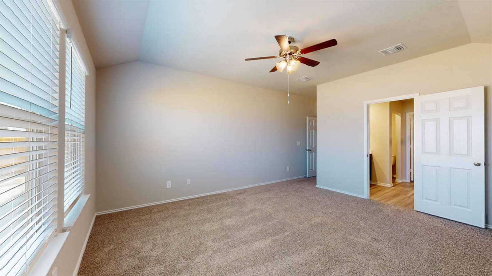 148 McNamara Court Jarrell, TX 76537 - Photo 11 of 22 Unfurnished bedroom with vaulted ceiling, light colored carpet, and ceiling fan
