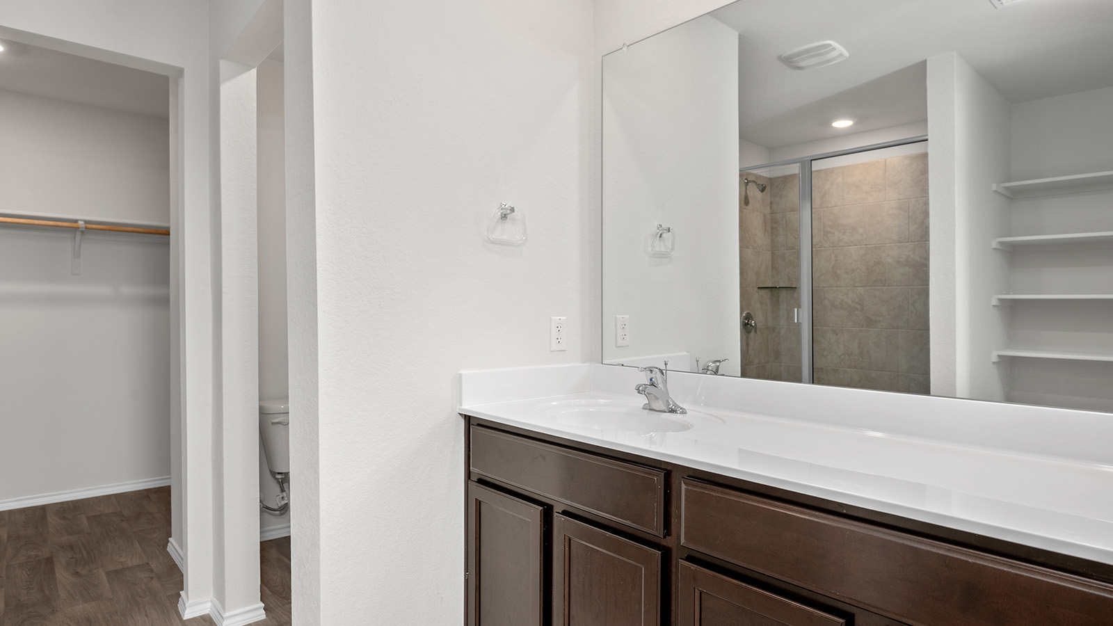 148 McNamara Court Jarrell, TX 76537 - Photo 12 of 22 Bathroom with a spacious closet, vanity, recessed lighting, a shower stall, and dark wood finished floors