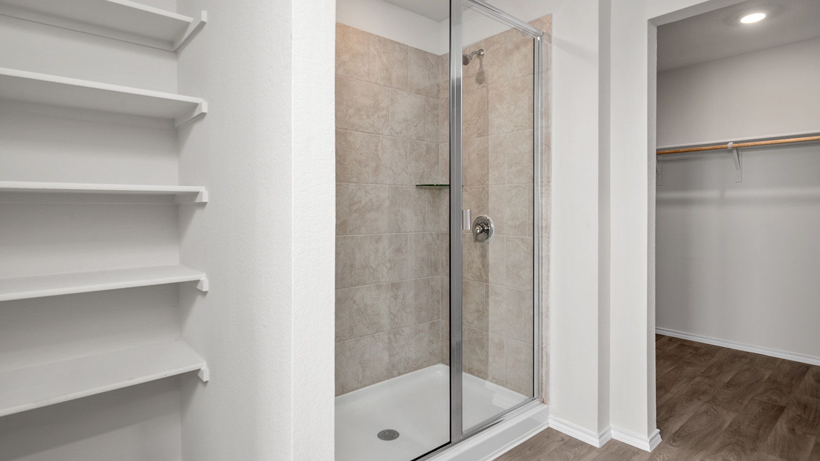 148 McNamara Court Jarrell, TX 76537 - Photo 13 of 22 Bathroom featuring a spacious closet, a shower stall, wood finished floors, and recessed lighting