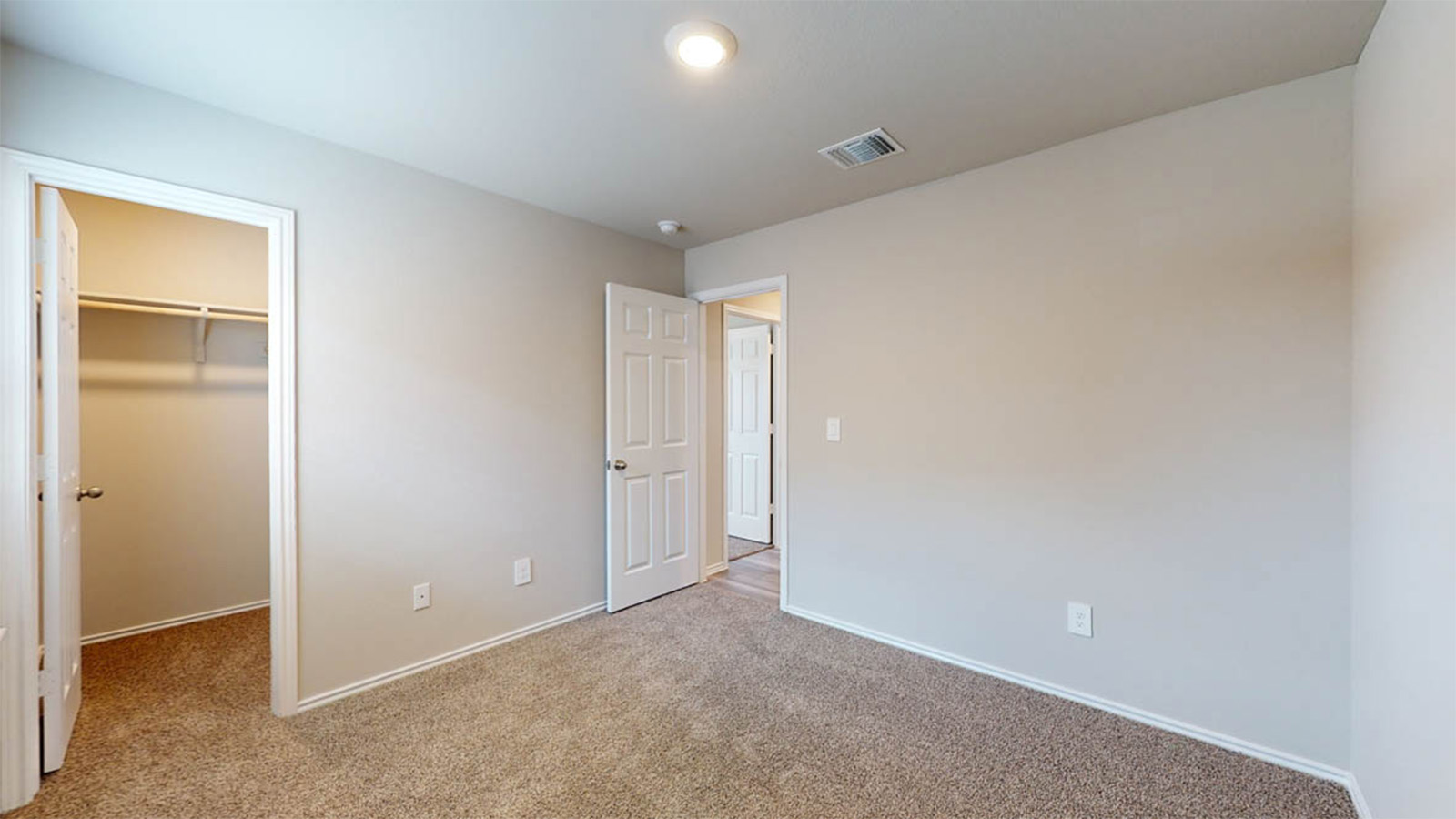 148 McNamara Court Jarrell, TX 76537 - Photo 16 of 22 Unfurnished bedroom featuring a walk in closet and light colored carpet