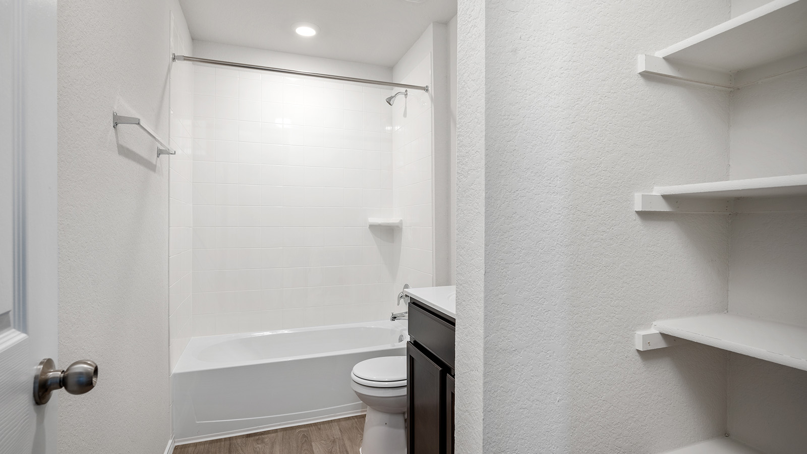 148 McNamara Court Jarrell, TX 76537 - Photo 19 of 22 Full bath with a textured wall, vanity, light wood finished floors, and shower / bath combination