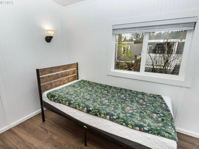 a wooden bench sitting in front of a window