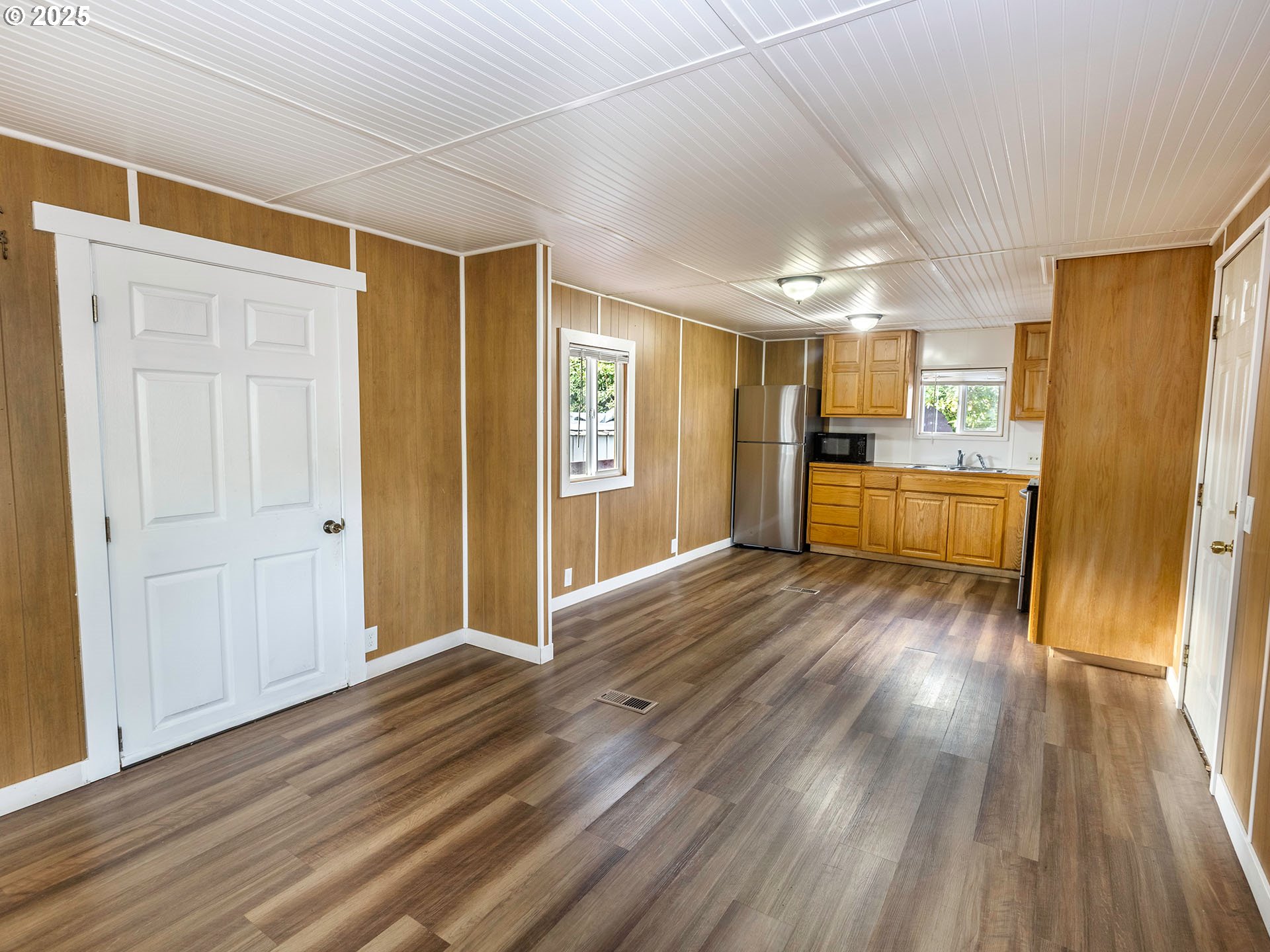 10701 Southeast Highway 212, Unit 13 Clackamas, OR 97015 - Photo 6 of 26 a view of a kitchen with a sink and a refrigerator