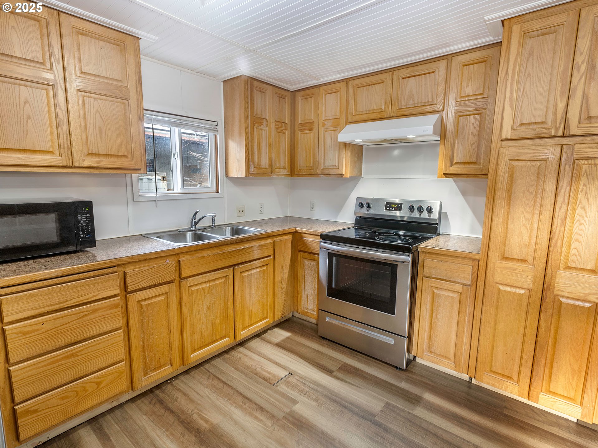 10701 Southeast Highway 212, Unit 13 Clackamas, OR 97015 - Photo 9 of 26 a kitchen with stainless steel appliances granite countertop a stove and a sink