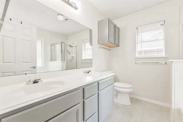 a bathroom with a sink toilet and a mirror