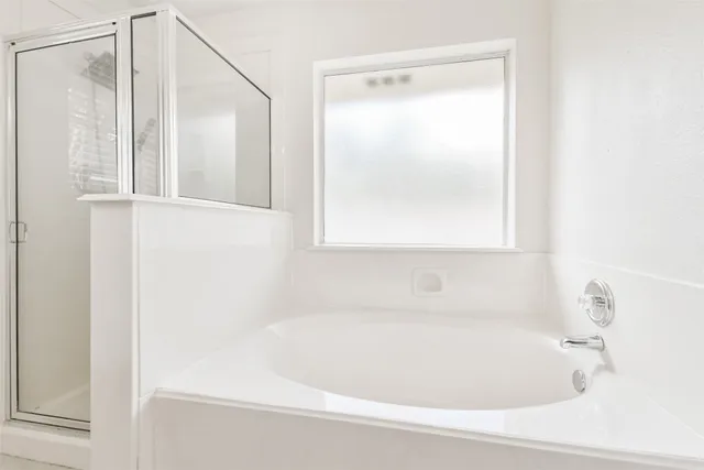 a white bath tub sitting next to a window