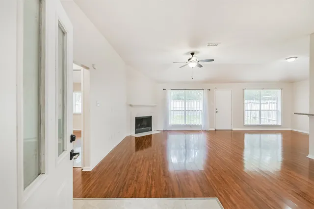wooden floor in an empty room with a window