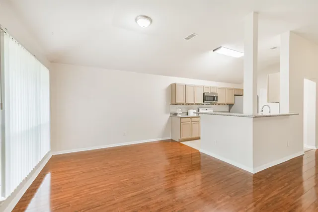 a view of a kitchen with wooden floor