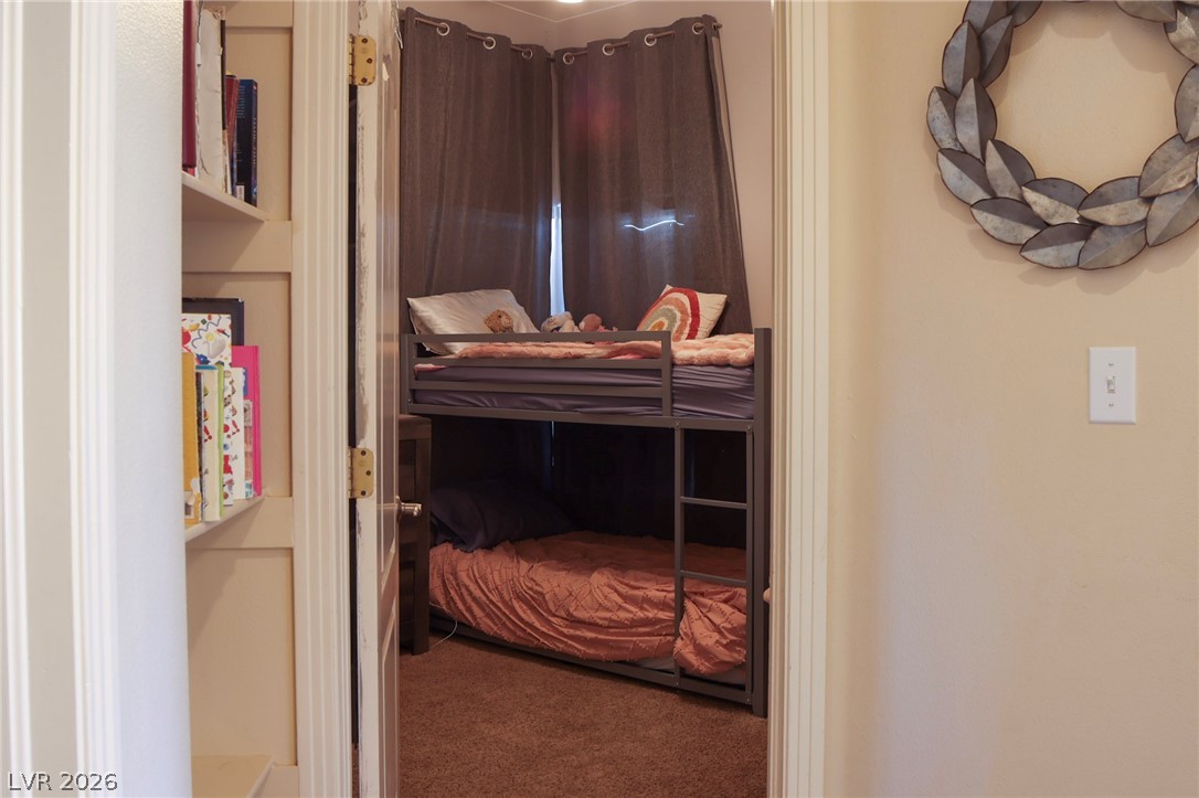 2775 Taylor Street Logandale, NV 89021 - Photo 26 of 41 This cozy bedroom features a clever bunk bed setup and soft carpeted flooring.