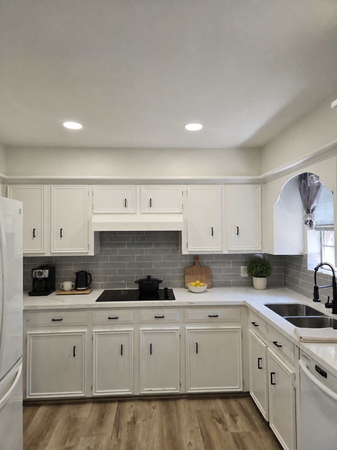 306 Houghton Road Katy, TX 77450 - Photo 9 of 34 Kitchen view showcasing crisp white cabinetry, tile backsplash, and generous counter and storage space. Virtually Staged