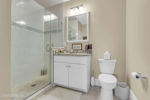 a bathroom with a toilet sink and shower