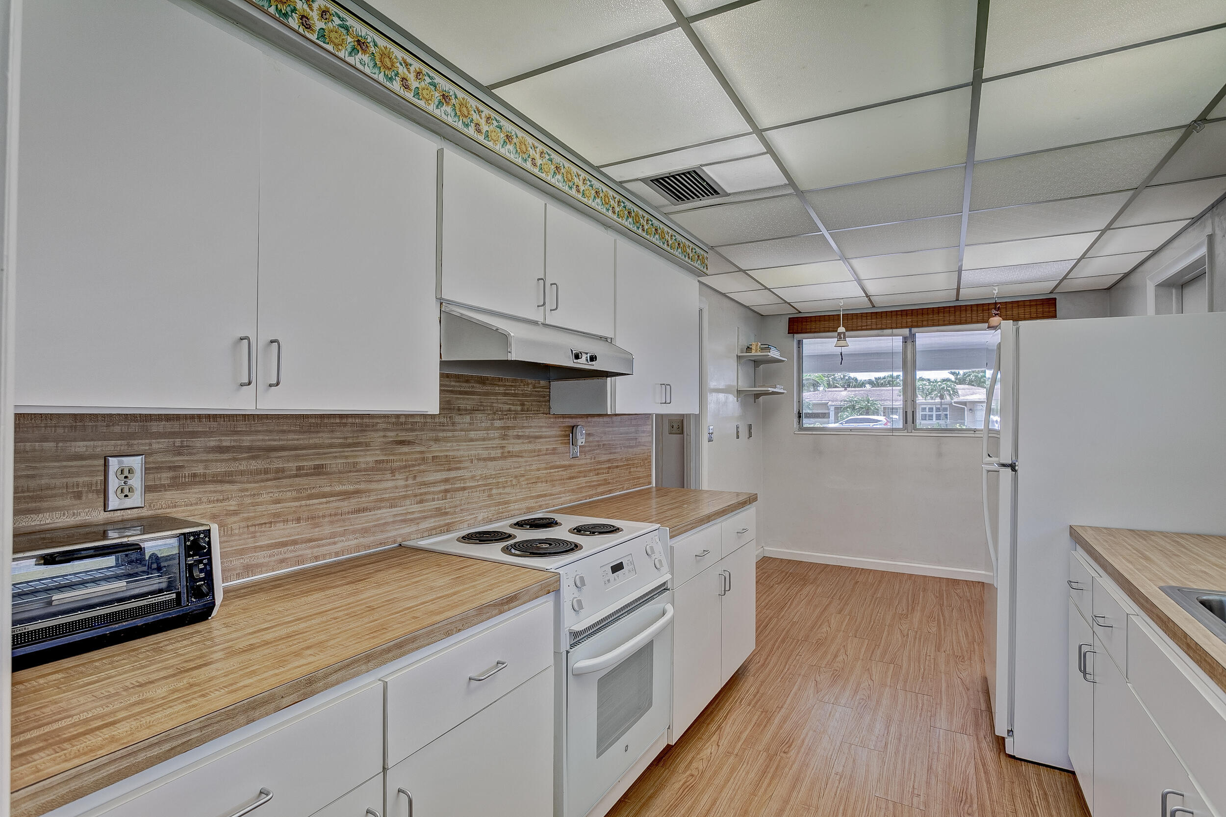 501 Inlet Road North Palm Beach, FL 33408 - Photo 15 of 58 a kitchen with granite countertop a sink a counter space stainless steel appliances and cabinets