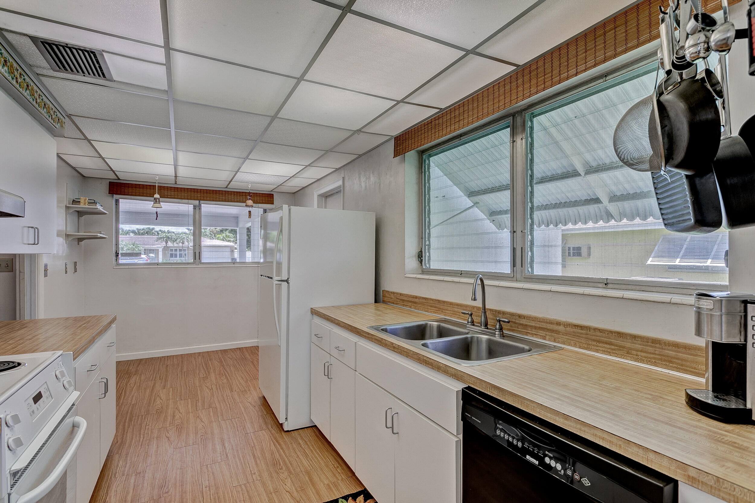 501 Inlet Road North Palm Beach, FL 33408 - Photo 16 of 58 a kitchen that has a sink a stove and a wooden floor