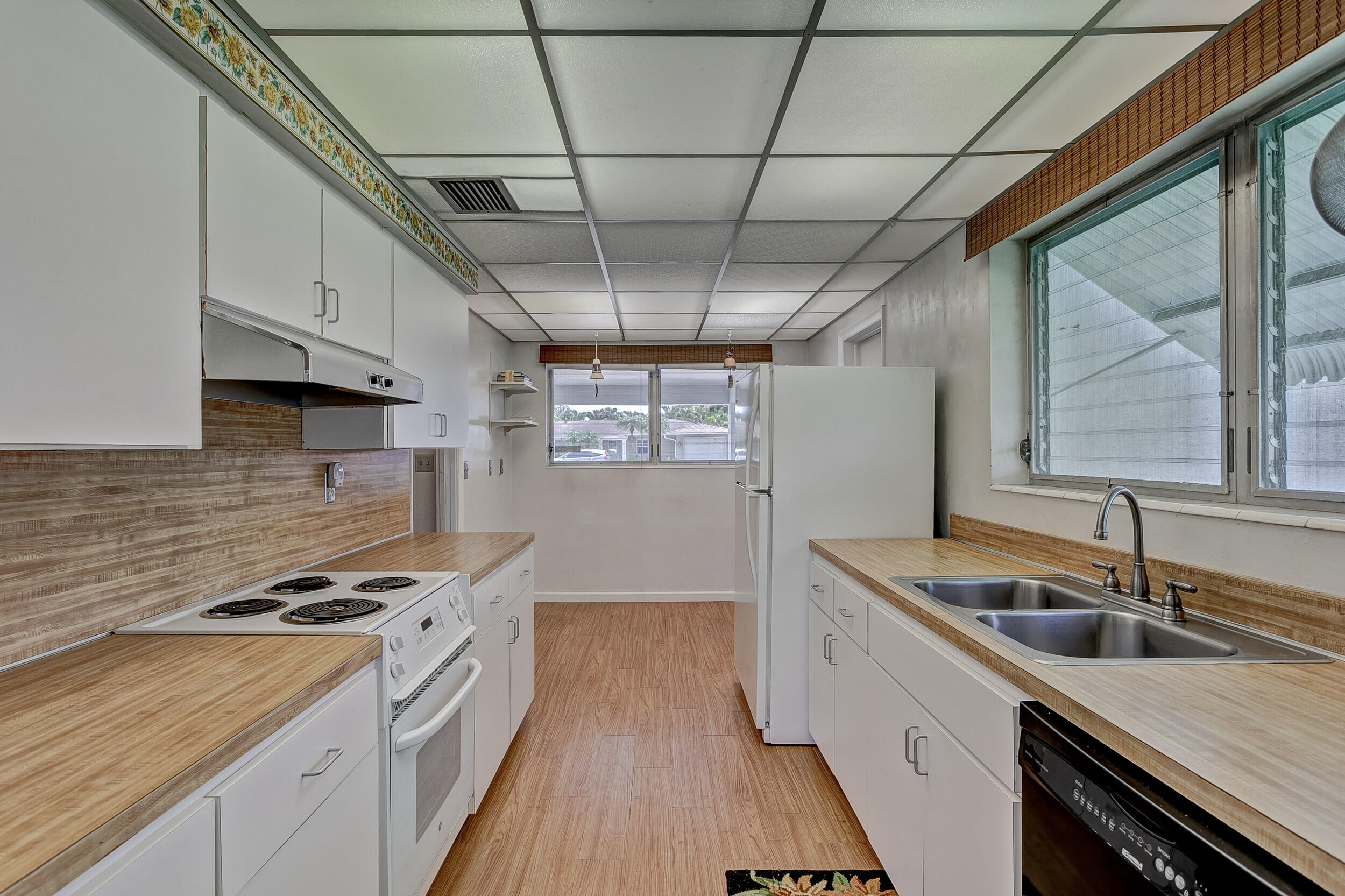 501 Inlet Road North Palm Beach, FL 33408 - Photo 20 of 58 a kitchen with stainless steel appliances granite countertop a sink a stove and a wooden floors