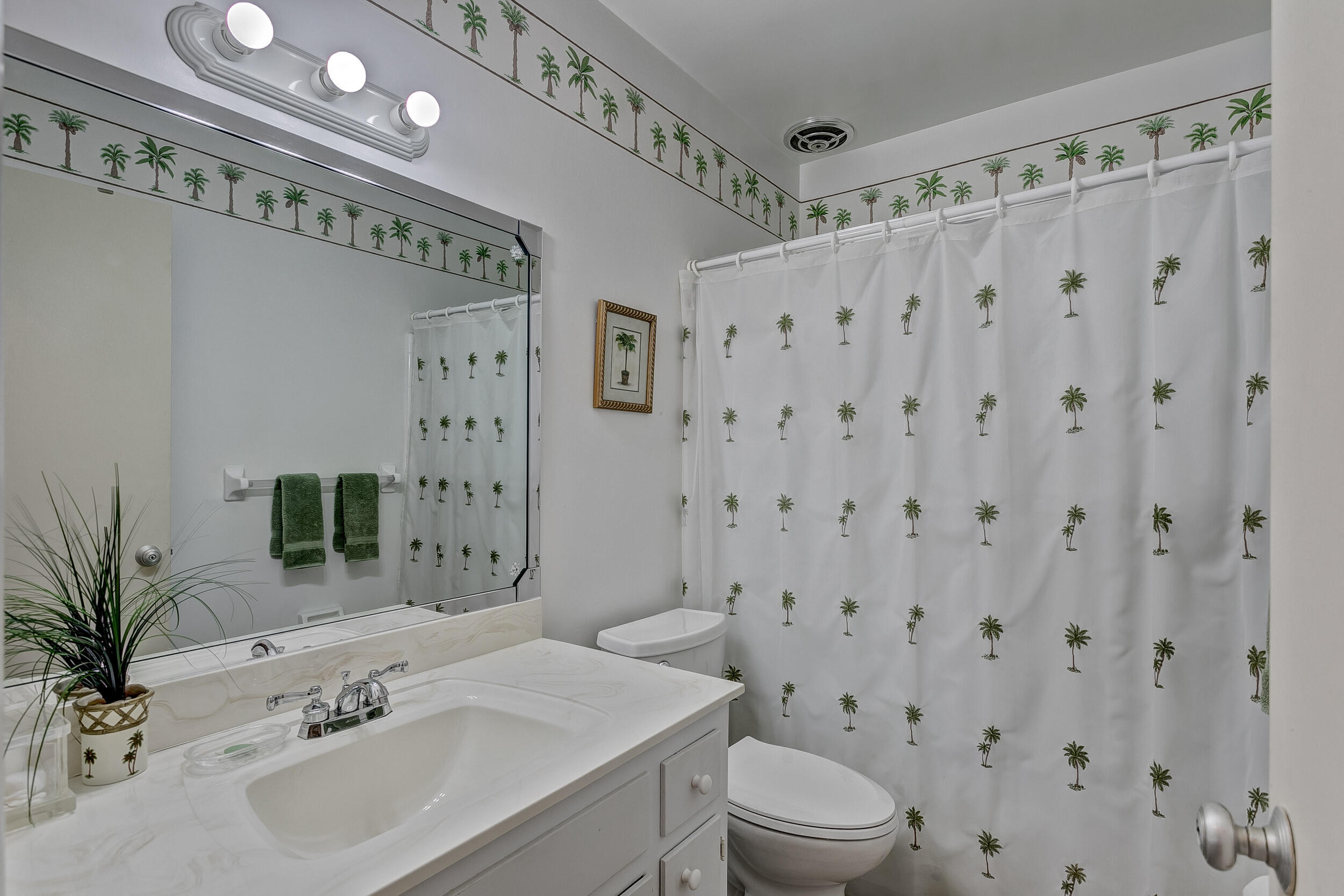 501 Inlet Road North Palm Beach, FL 33408 - Photo 23 of 58 a bathroom with a sink a toilet and shower curtain