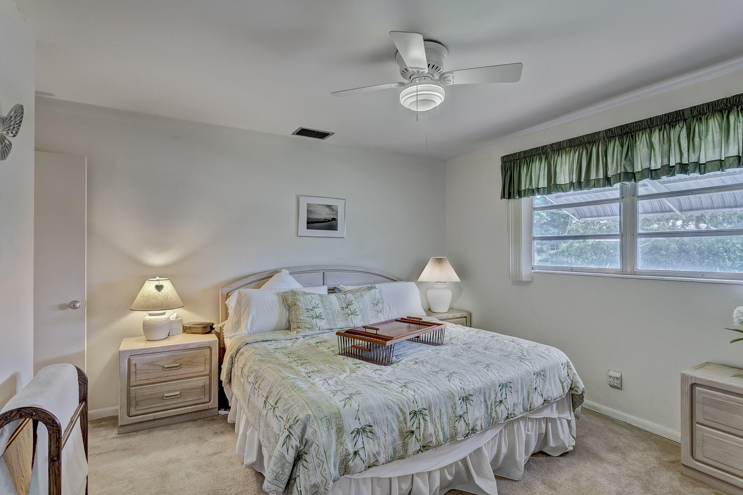 501 Inlet Road North Palm Beach, FL 33408 - Photo 25 of 58 a bedroom with a bed and a chandelier