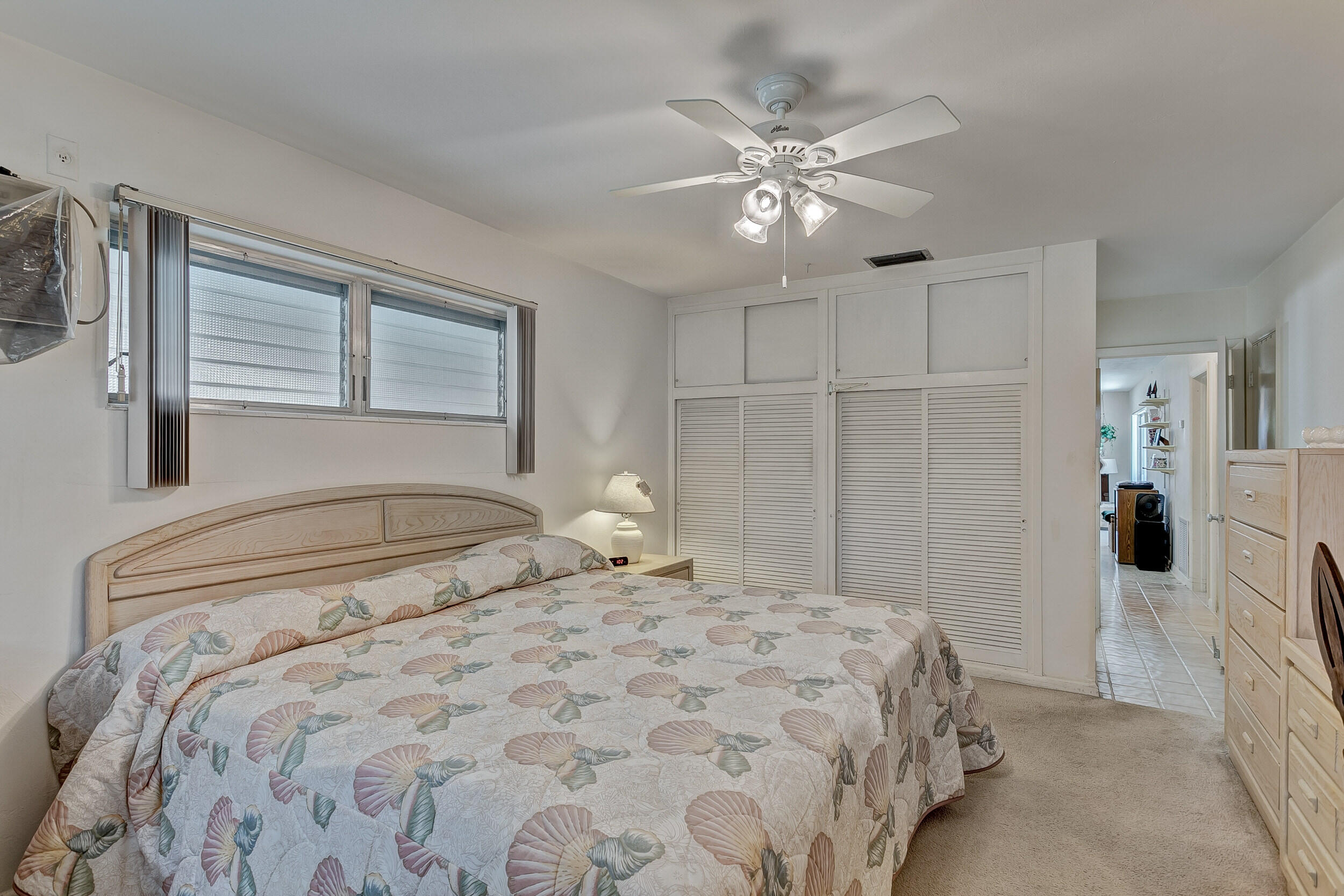 501 Inlet Road North Palm Beach, FL 33408 - Photo 28 of 58 a bedroom with a large bed and a chandelier