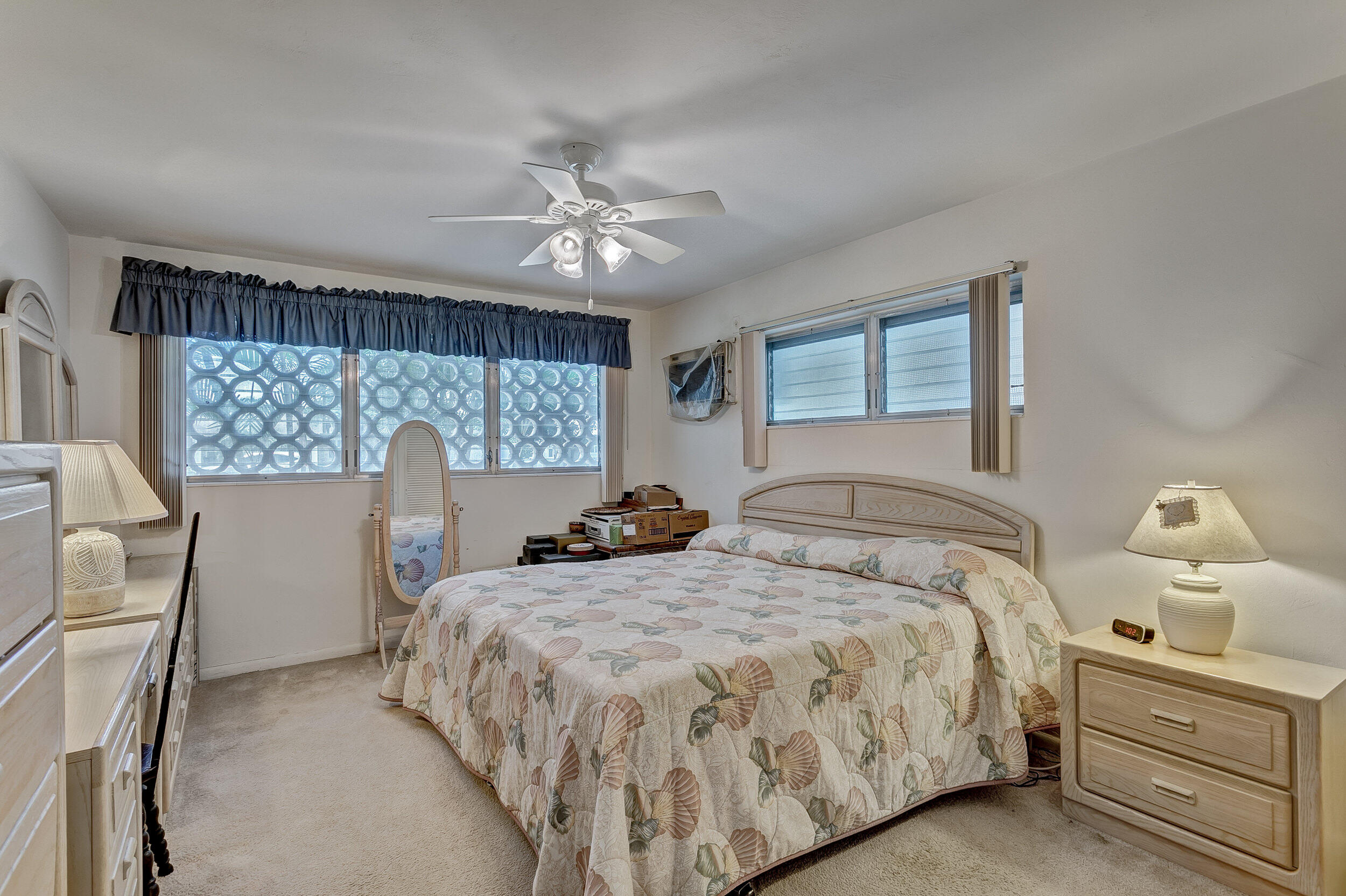 501 Inlet Road North Palm Beach, FL 33408 - Photo 30 of 58 a bedroom with a bed and wooden floor