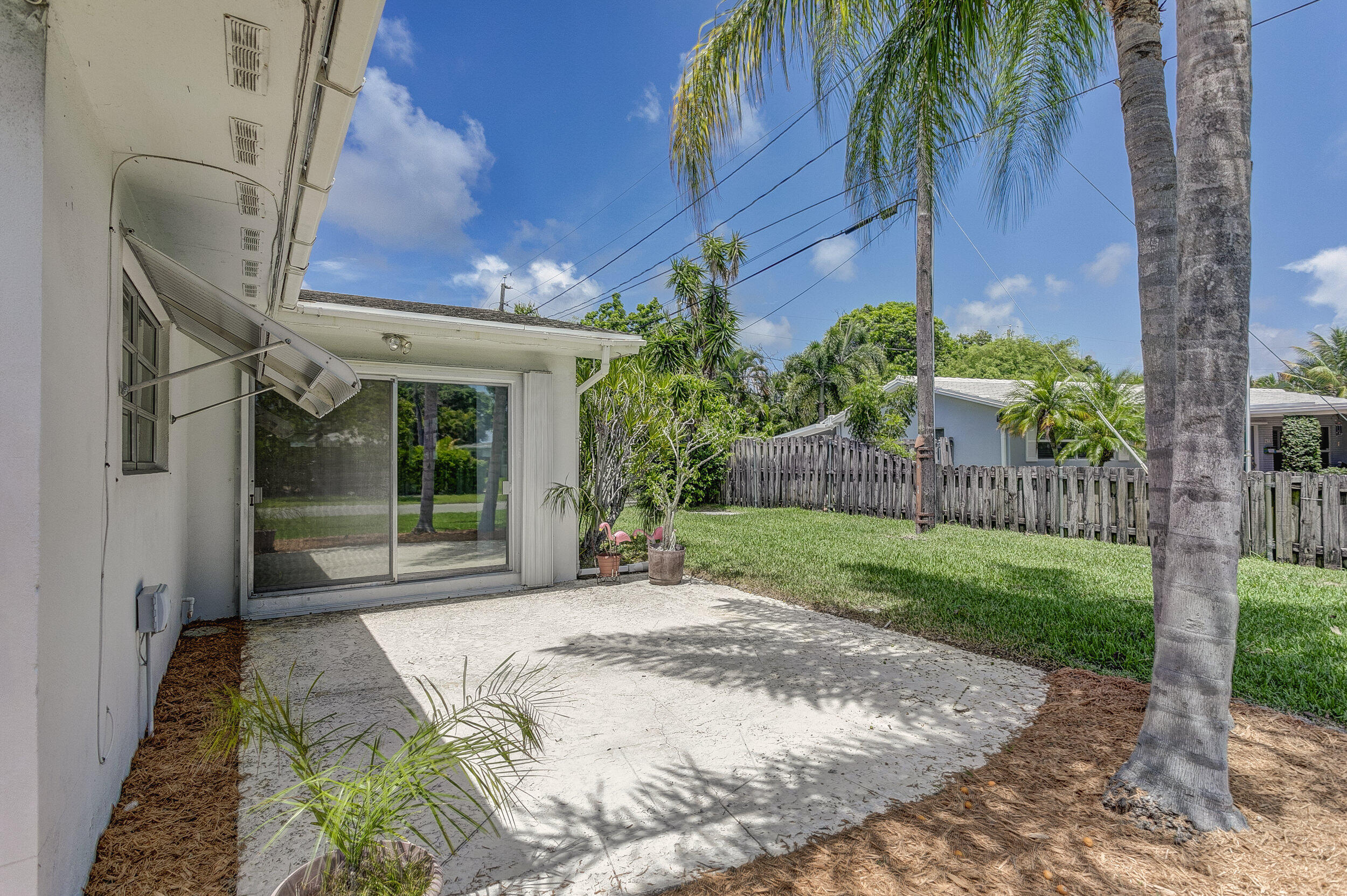 501 Inlet Road North Palm Beach, FL 33408 - Photo 33 of 58 a front view of a house with a yard and potted plants