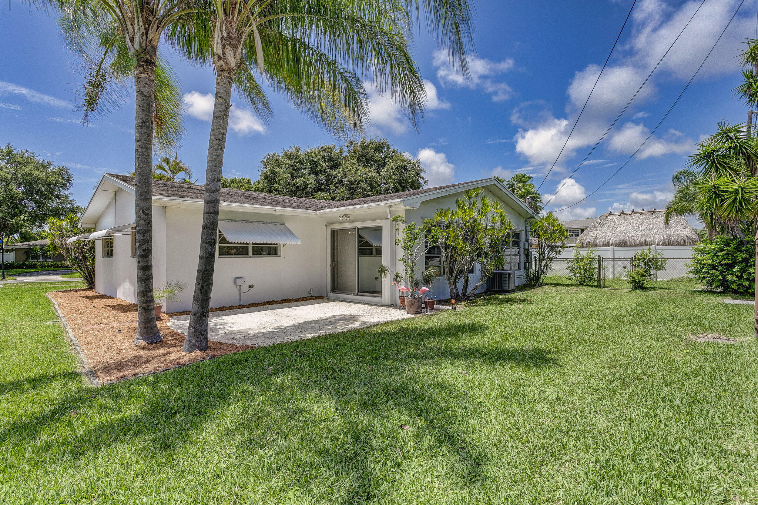 501 Inlet Road North Palm Beach, FL 33408 - Photo 34 of 58 a view of a house with a yard and palm trees