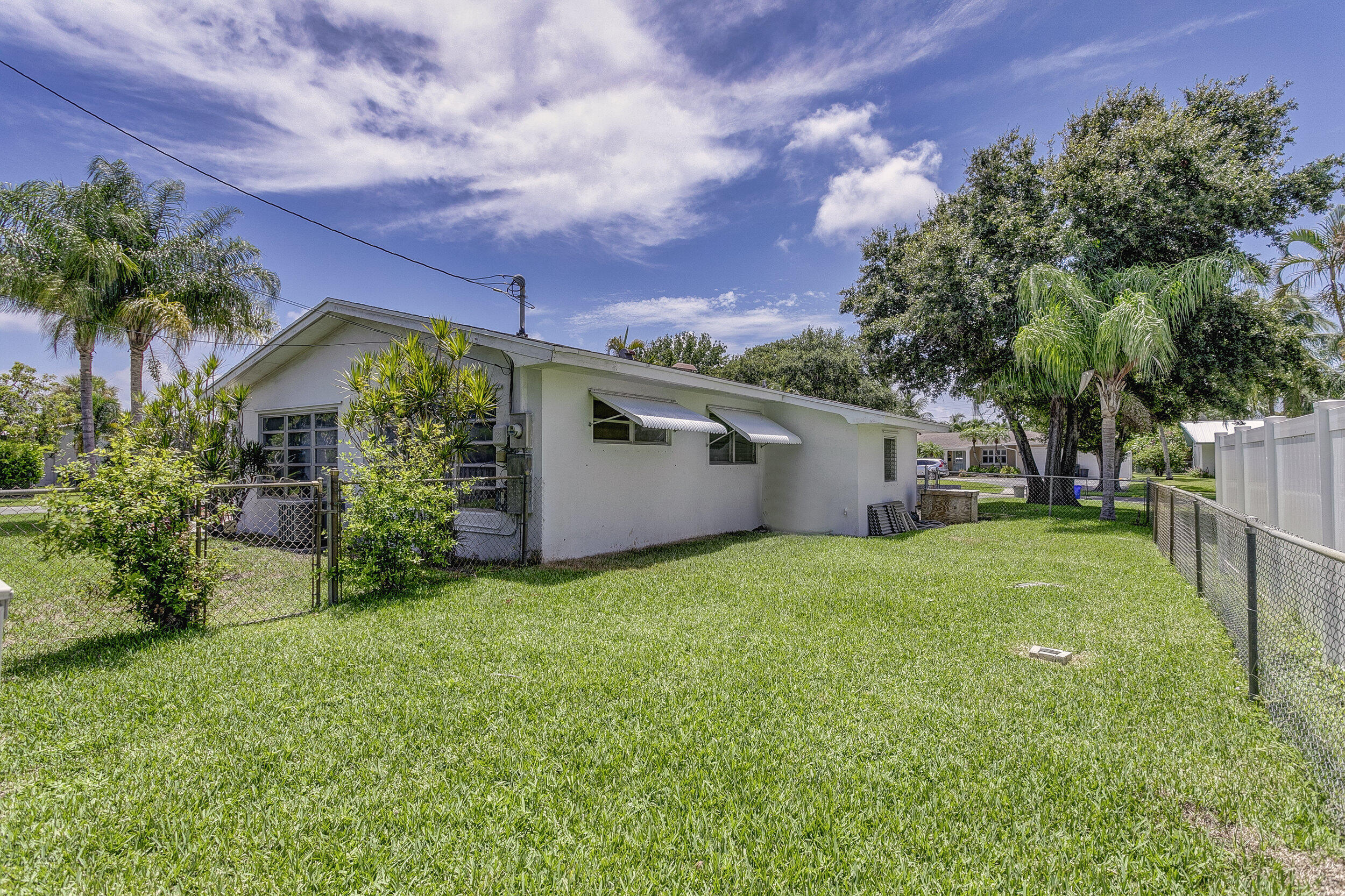 501 Inlet Road North Palm Beach, FL 33408 - Photo 41 of 58 a view of a house with a large tree and a yard