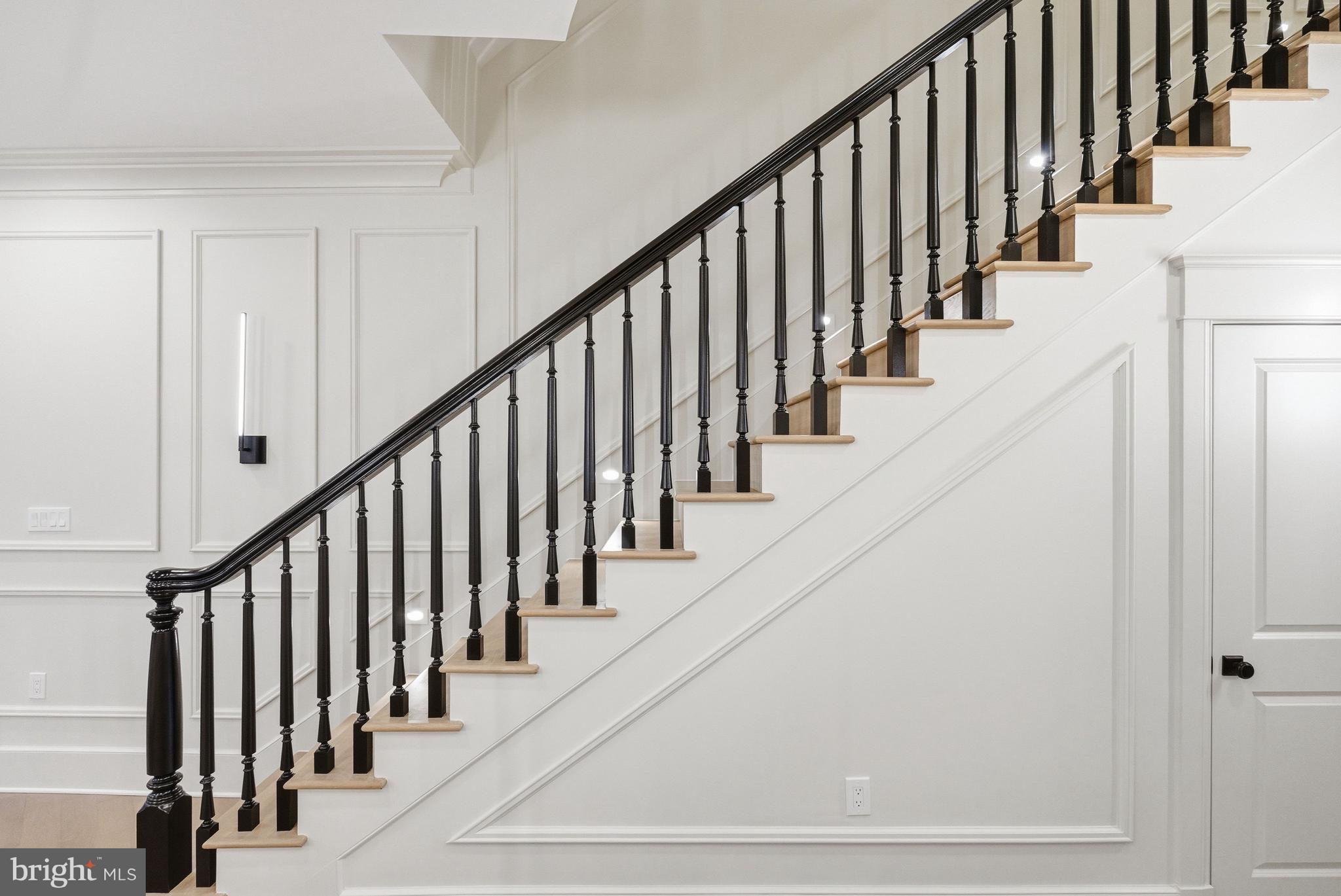 1816 Belmont Road Northwest Washington, DC 20009 - Photo 11 of 62 a view of staircase with lots of frames on wall and wooden floor