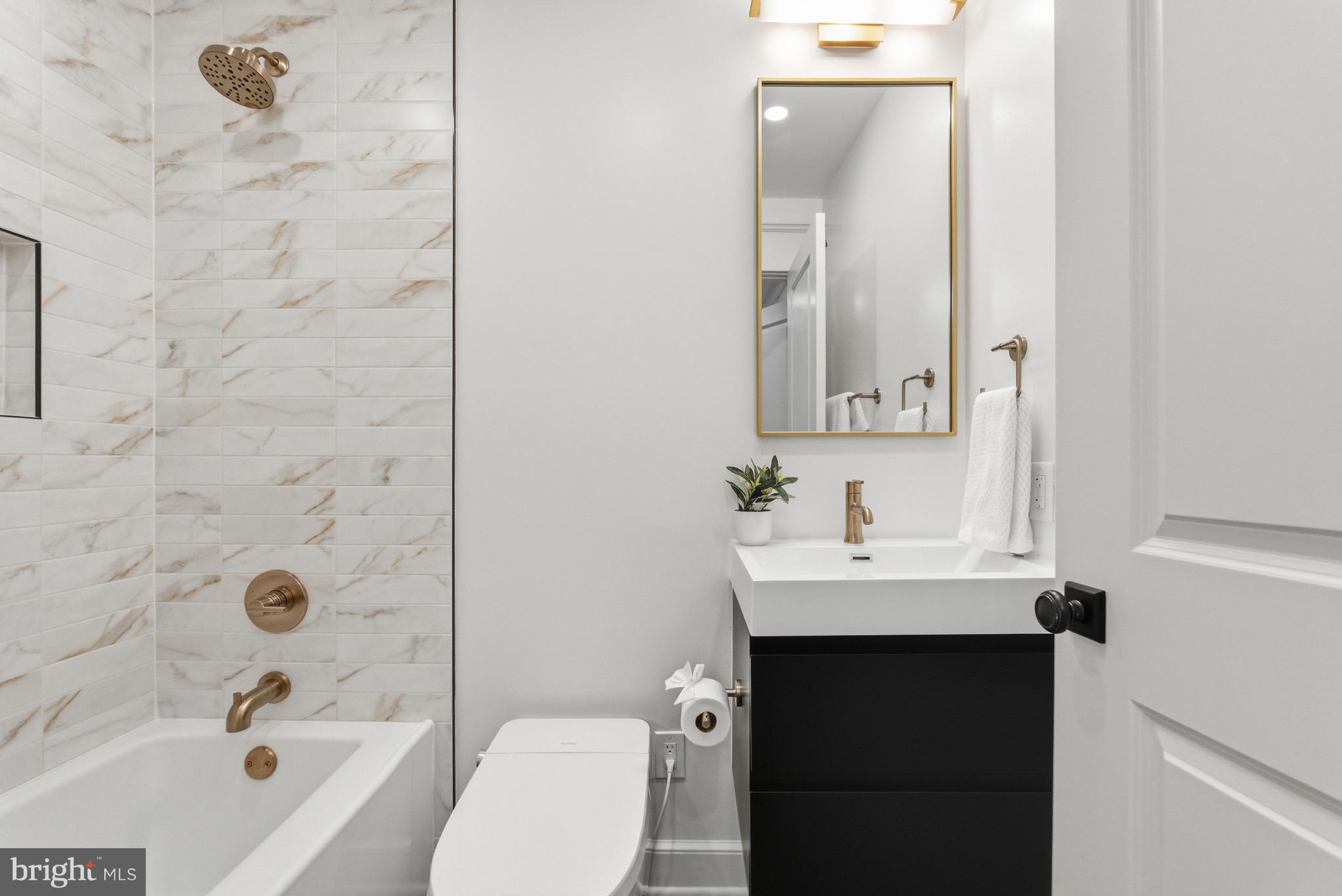 1816 Belmont Road Northwest Washington, DC 20009 - Photo 51 of 62 a bathroom with a sink a toilet and shower