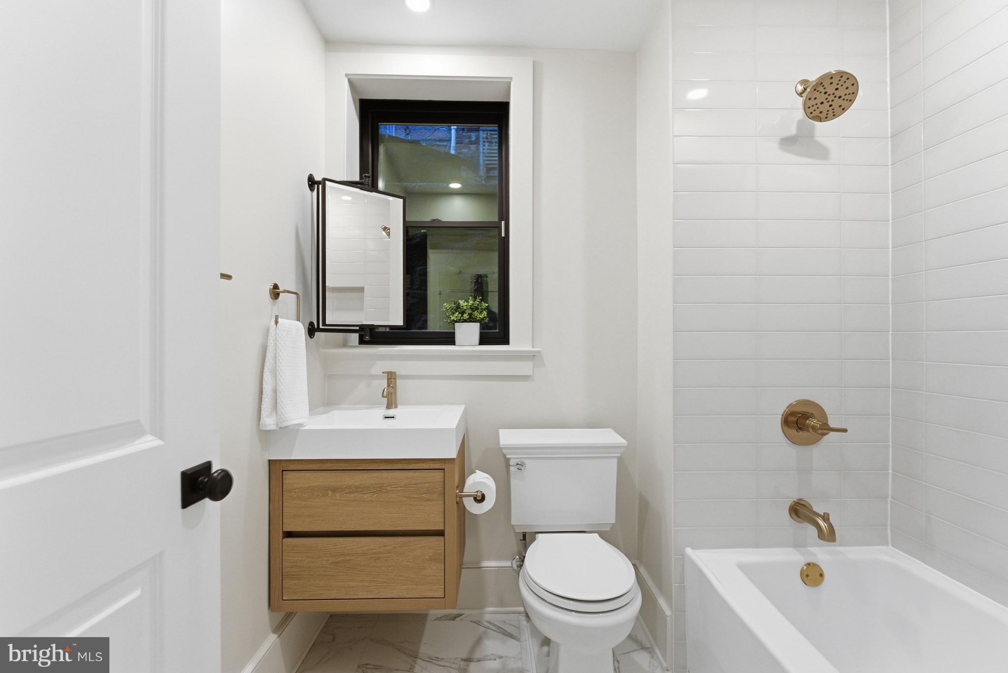 1816 Belmont Road Northwest Washington, DC 20009 - Photo 61 of 62 a bathroom with a sink a toilet and shower