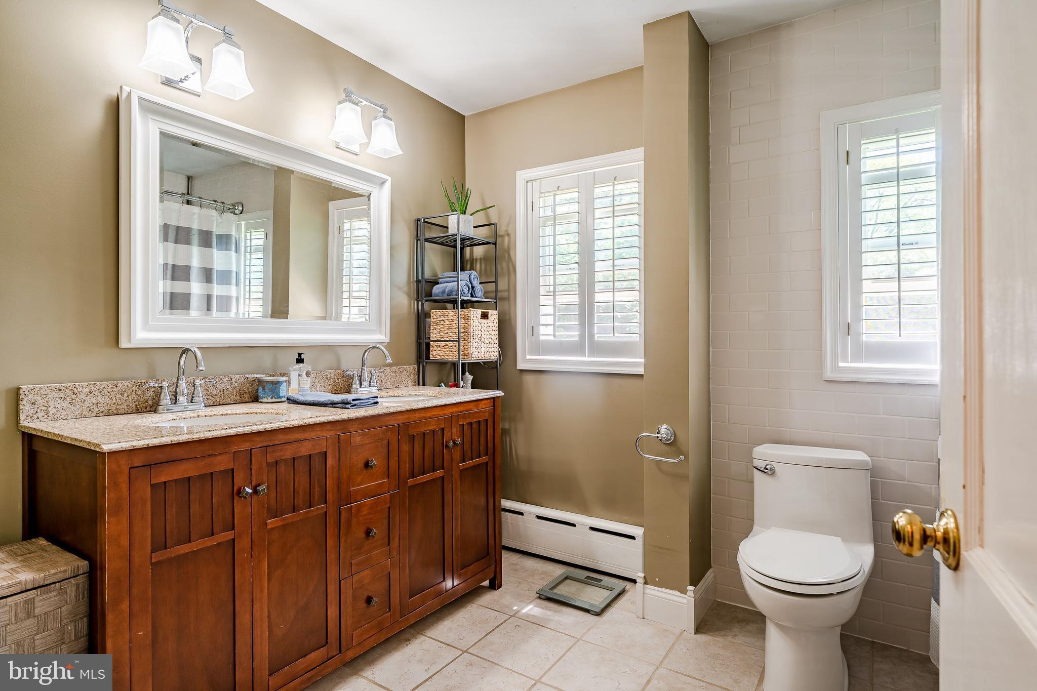 1538 Carmac Road West Chester, PA 19382 - Photo 13 of 33 a bathroom with a toilet sink and mirror