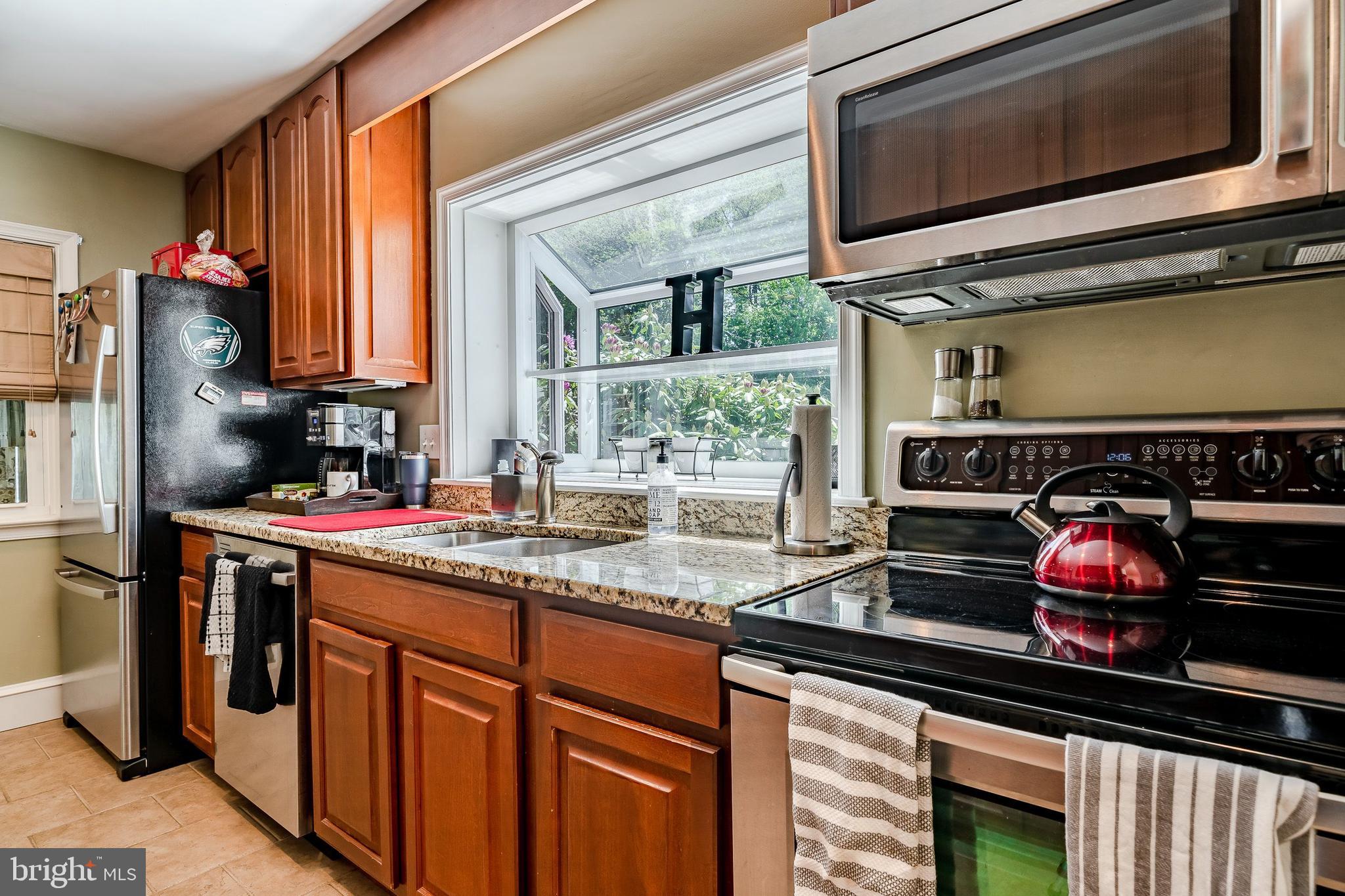 1538 Carmac Road West Chester, PA 19382 - Photo 19 of 33 a kitchen with stainless steel appliances a stove and a microwave