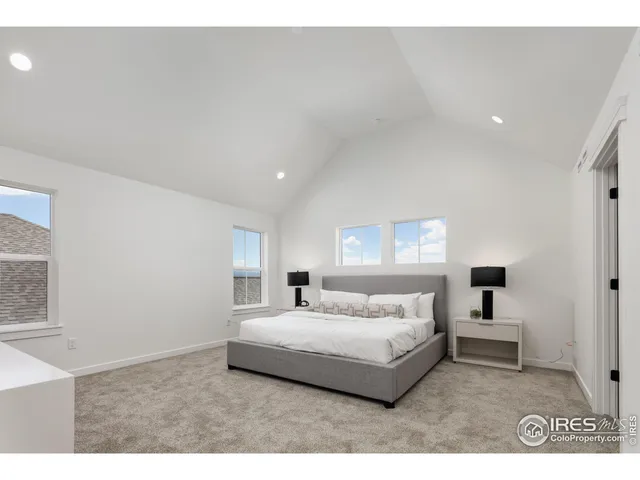 a bedroom with a bed and a night stand