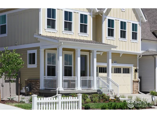 a view of a brick building next to a yard
