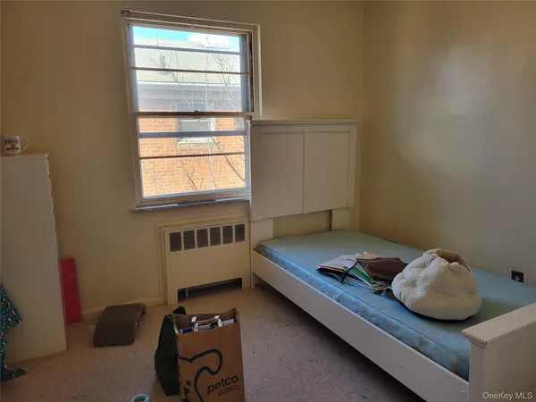 a bedroom with a bed and window