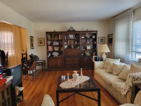a living room with furniture a dining table and a bookshelf