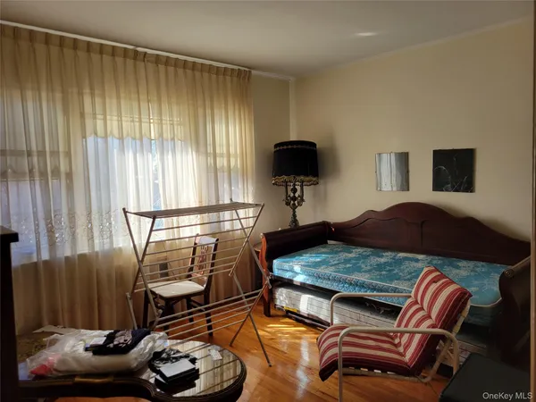 a bedroom with furniture and a window