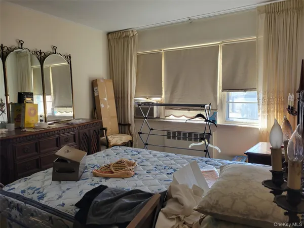 a bedroom with furniture and a window